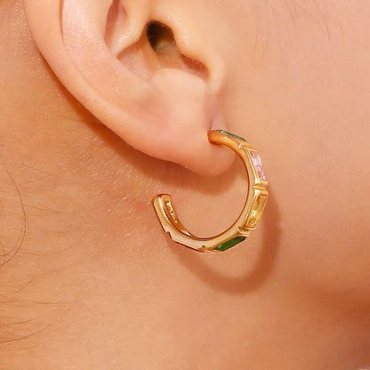 Detailed shot highlighting the unique bamboo-inspired design and sparkling zircon stones of the C-shaped hoop earring.
