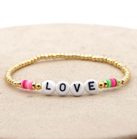 Close-up of the 'LOVE' beaded letter bracelet with gold and colorful beads.