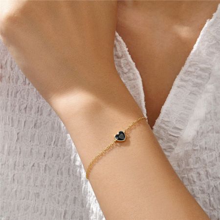 A stylish look featuring the gold bracelet with a chic black enamel heart charm.