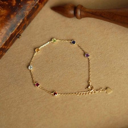 Detailed view of the multicolored cubic zirconia stones on the 18K gold plated sterling silver bracelet.