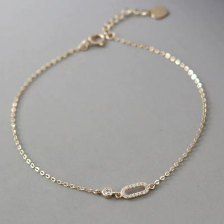Close-up of a geometric cubic zirconia bracelet from the set, worn on a wrist to show detail.