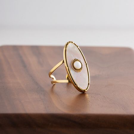 Bague en or élégante avec une pierre en coquille blanche ovale et un accent délicat en perle.