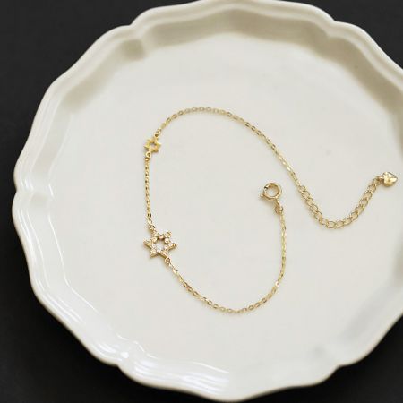 Detailed view of the gold-plated 925 sterling silver bracelet with a six-pointed star charm, displayed on a white surface.