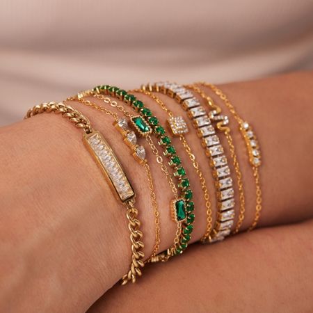 A collection of custom gold plated bangles with various gemstone options.