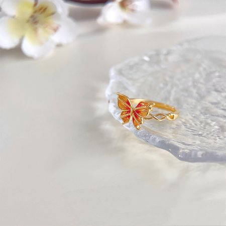 Another angle of the vibrant enamel butterfly ring, highlighting the gold finish.