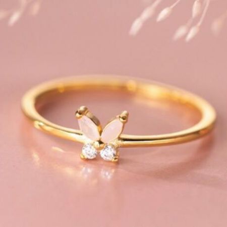 Elegant gold butterfly ring featuring delicate pale pink and clear gemstones.