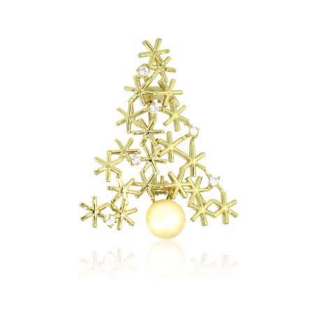 Angled view of the gold Christmas tree brooch made of snowflakes and a ball.