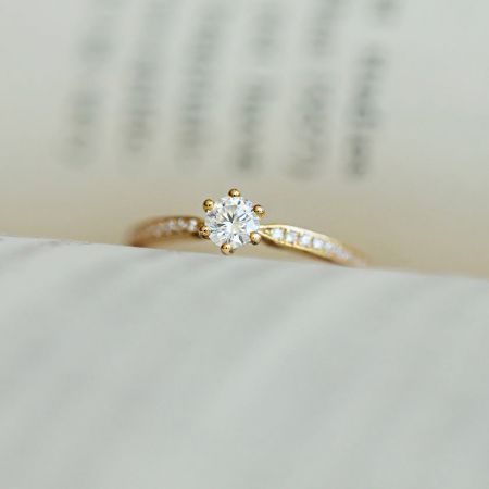 Front view of the gold-plated CZ solitaire ring highlighting its brilliance and classic six-prong setting.