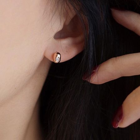 Model wearing the sparkling cubic zirconia bean-shaped stud earring.