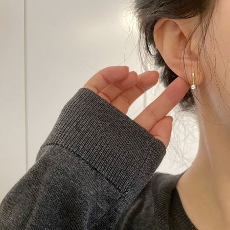 Model wearing the gold zircon threader earring to show scale and style.