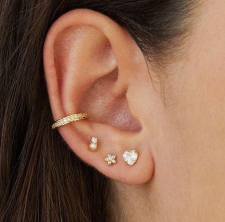 Vue rapprochée du jeu de boucles d'oreilles en or 18 carats, mettant en valeur les détails complexes des pierres en zircon cubique.