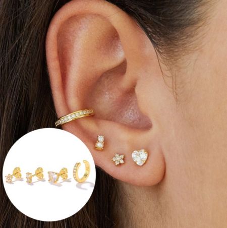 Modèle présentant le jeu de boucles d'oreilles en or 18 carats, comprenant des designs en créoles, perles, fleurs et cœurs.