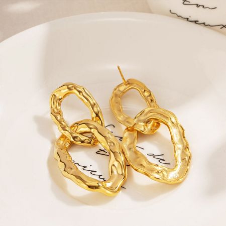 A pair of stainless steel chunky gold elliptical interlock charm drop earrings.