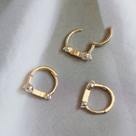 Un assortimento di orecchini huggie in zirconia in argento sterling dai cinque paia.