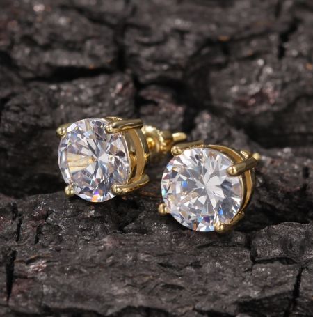 Round Moissanite Solarite Earrings - A pair of custom Round Moissanite Solarite Earrings in a brilliant gold setting, featuring large, sparkling clear gemstones against a dark background.