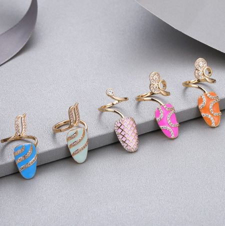 A collection of gold earrings with vibrant enamel designs, representing the style of the Spring/Summer collection.
