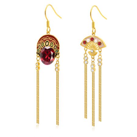 Close-up detail of the Chinese Opera Mask earring, showing intricate gold work, red and white gemstones, and delicate dangling chains.