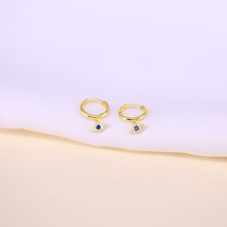 The gold-plated version of the evil eye hoop earrings with blue and white gemstones.