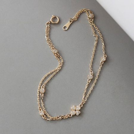Another angle of the lucky four-leaf clover bracelet, highlighting its layered design and brilliant finish.