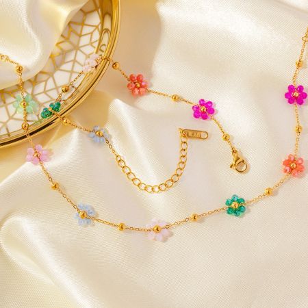Detailed view of the gold floral necklace showing the lobster clasp and extender chain.