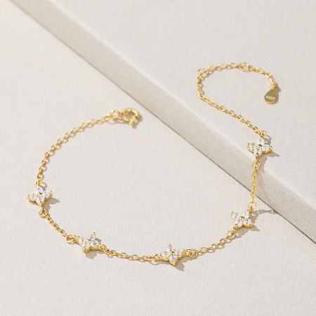 Close-up of the intricate four-leaf clover charm with shimmering zircon stones.