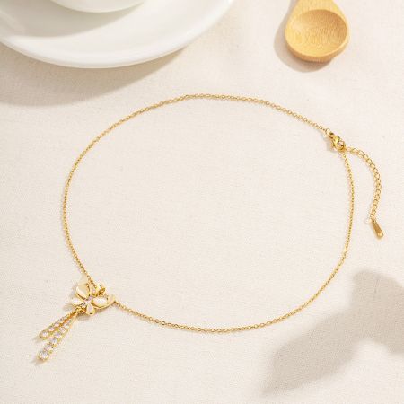 Charmant collier pendentif en or en forme de fleur, montrant la variété au sein de l'ensemble de bijoux en acier inoxydable.