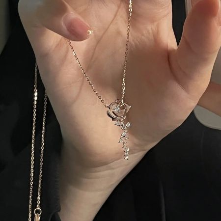 A stunning gold necklace featuring an intricate flower-shaped pendant.