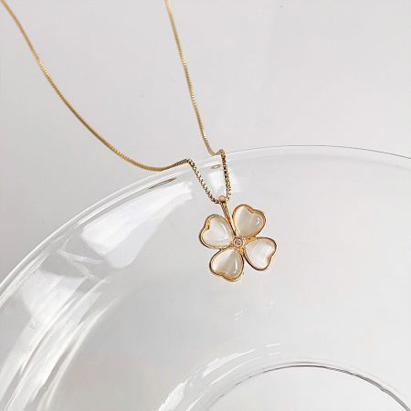 Gold Plated Rhinestone & Cat-Eye Opal Pendant Necklace Set - A gold-plated necklace from a 5-piece set, featuring a flower pendant with white cat-eye stone heart-shaped petals and a central rhinestone.