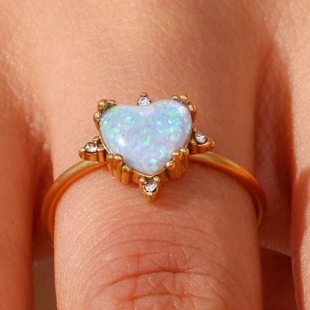 Detailed view of the heart-shaped adjustable stainless steel opal ring.