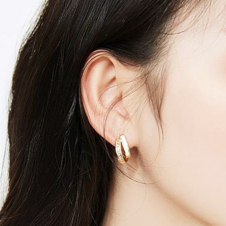 Model showcasing the geometric cross zirconia stud earring.
