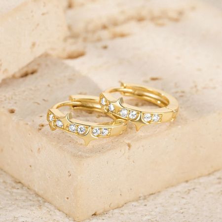 Gold variant of the star zircon hoop huggie earrings.