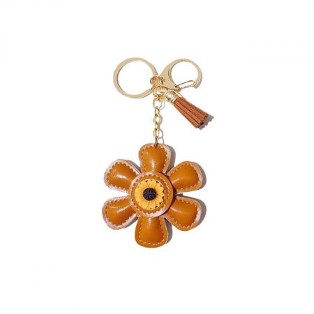 Detailed view of the gold keychain attachment on the orange sunflower charm.