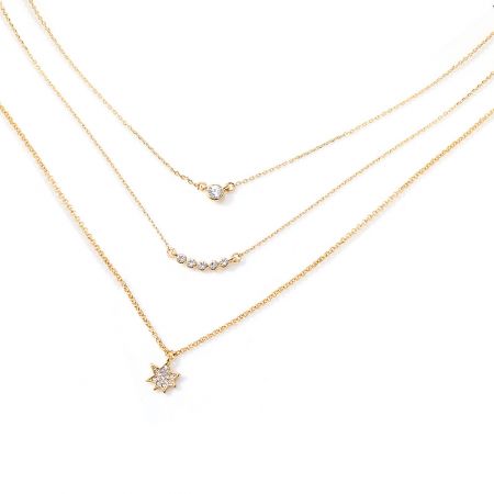Star Layer Necklace - Detailed view of the Star Layer Necklace, showing three delicate gold chains with various diamond and star-shaped cubic zirconia pendants.