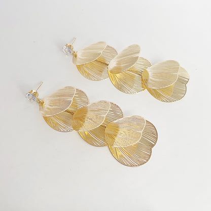 18k Gold Plated Hollow-Out Ginkgo Leaf Statement Drop Earrings - A close-up of the 18k gold plated ginkgo leaf statement drop earrings, showcasing the intricate hollow-out design and a small decorative diamond.