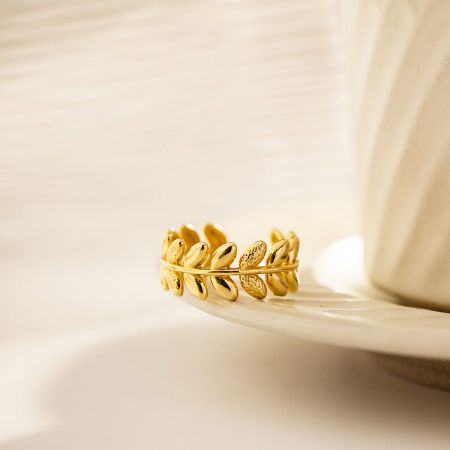 Close-up view of the textured surface of the gold leaf split open ring.
