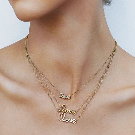 Gelaagd uitzicht van drie gouden liefde kettingen, die laat zien hoe je de choker kettingen van roestvrij staal kunt stylen voor een moderne look.