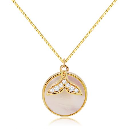 A detailed view of the gold necklace with its distinctive mermaid tail pendant.