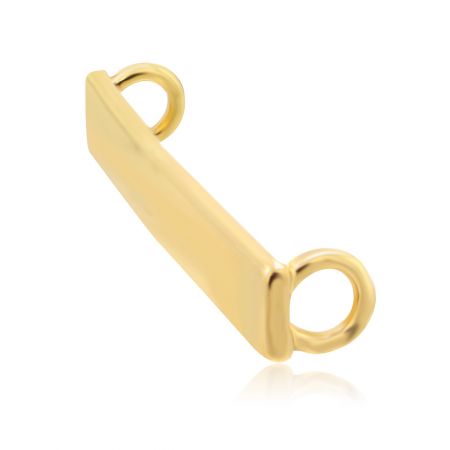 Close-up of the gold shoelace charm's connector loops for threading laces.