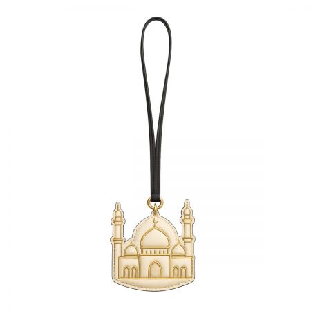 An elegant gold-colored charm designed in the shape of a mosque, reflecting Dubai's rich culture.