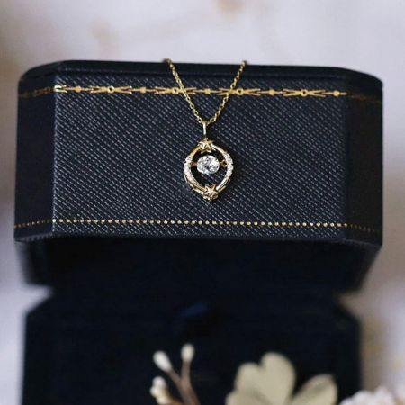 Detail of a celestial-themed pendant from the collection, featuring a crescent moon and star design.