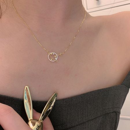 Detailed view of the Saturn planet necklace with a star-studded pendant.