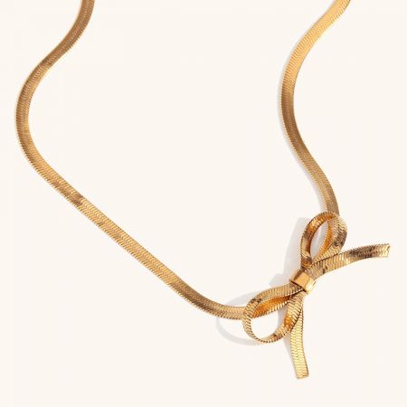 Close-up of the adjustable clasp on the gold bow necklace, ensuring a perfect fit.