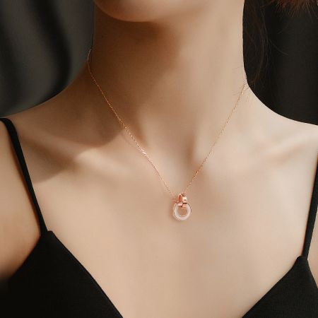 The Stainless Steel Chain Rings Necklace in gold, elegantly worn to showcase its style.