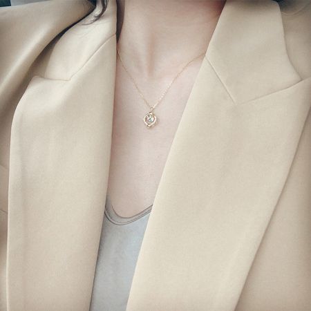 Model wearing the gold-plated sterling silver star zircon necklace, showcasing its elegant drape.