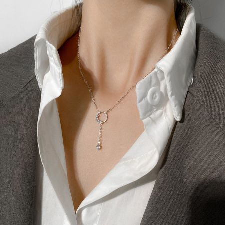 A model showcasing the 925 sterling silver circle tassel pendant necklace against a neutral background.