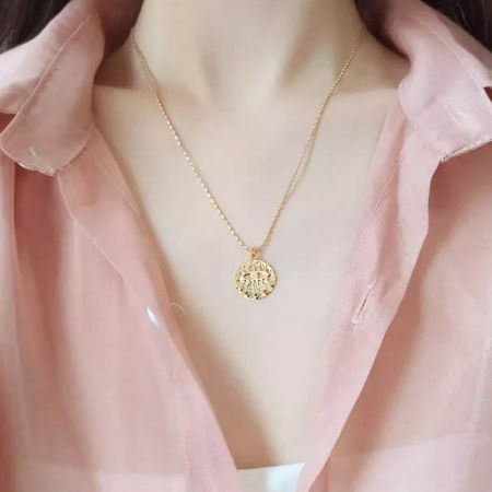 Product showcase of the circular evil eye pendant necklace against a clean background.