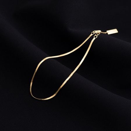 A model styling the minimalist silver anklet, perfect for summer and beachwear.