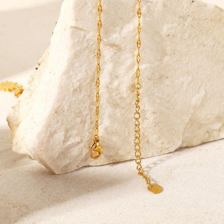 Detail of the necklace's secure gold clasp and extension chain.