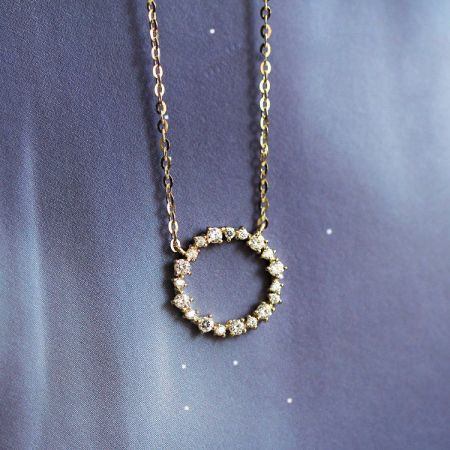 Collana con pendente a corona di zirconio in argento sterling 925 - Un primo piano del collier con pendente a corona di zirconio in argento sterling 925, che mette in risalto le pietre scintillanti incastonate in un design circolare.