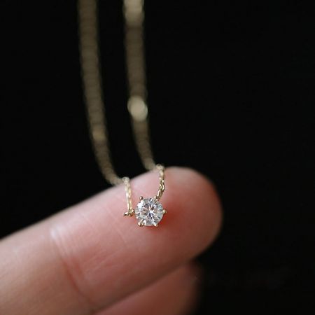 Alternate angle of the 925 silver solitaire pendant necklace with gold finish.